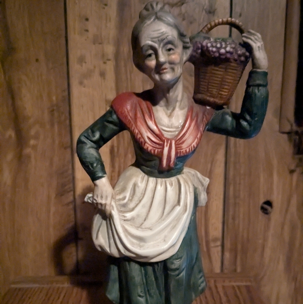 Figurine, Lady carrying basket on shoulder and holding up her apron